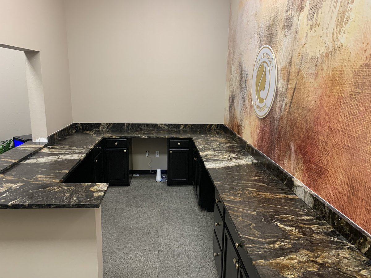 Commercial reception desk with dark stone countertops.