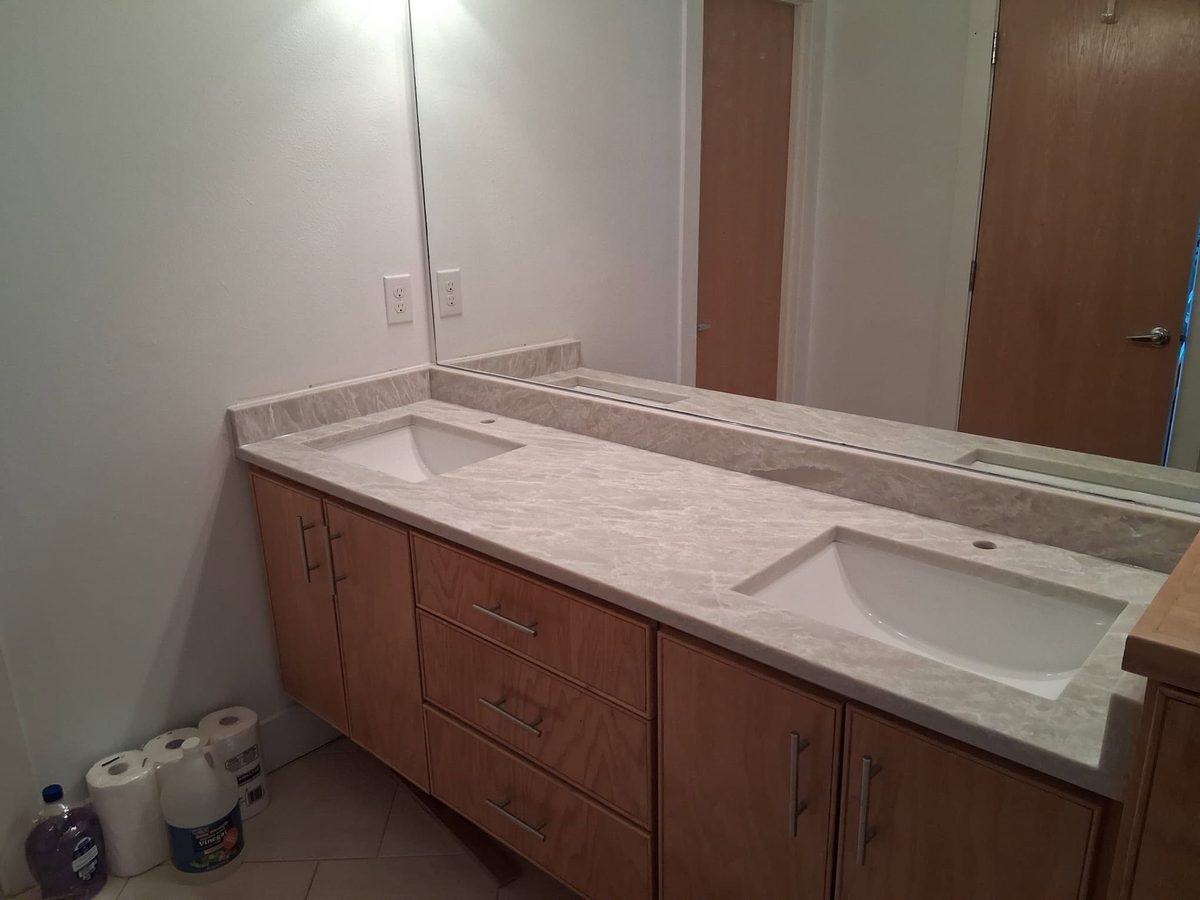 Double vanity with a light stone top and two undermount sinks.