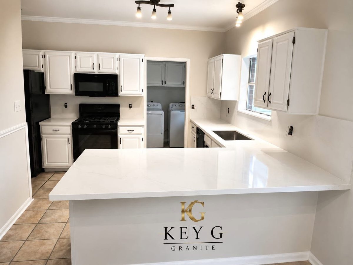 Kitchen peninsula with a white quartz top wrapping to the sink counter.