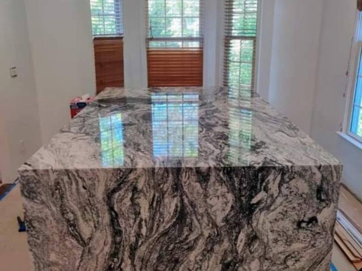 Kitchen island with dark patterned stone.